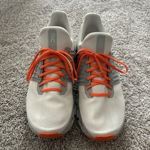 On Running White and Orange Athletic Shoes